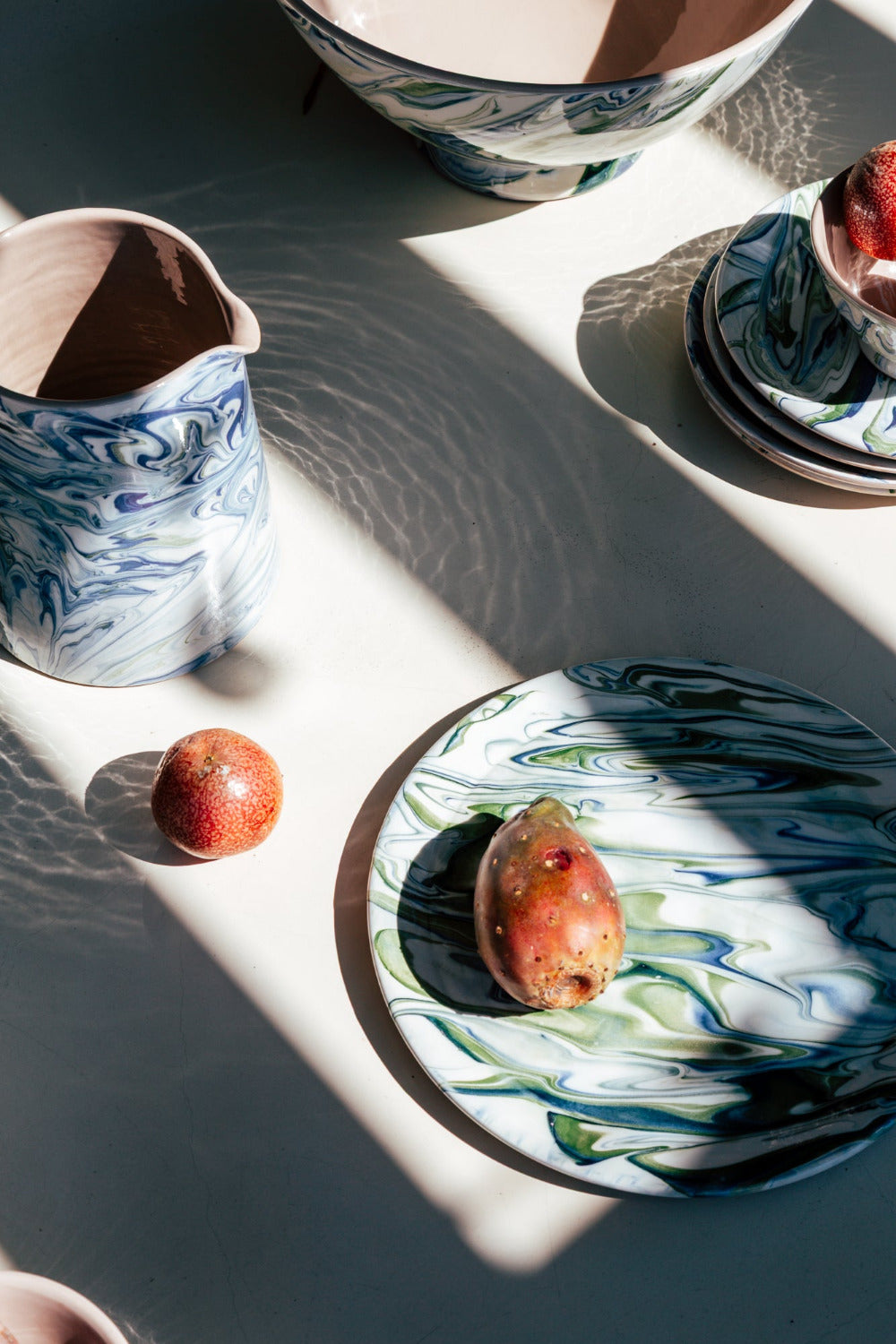 Ceramic plates and bowls with blue and white patterns on a light surface.
