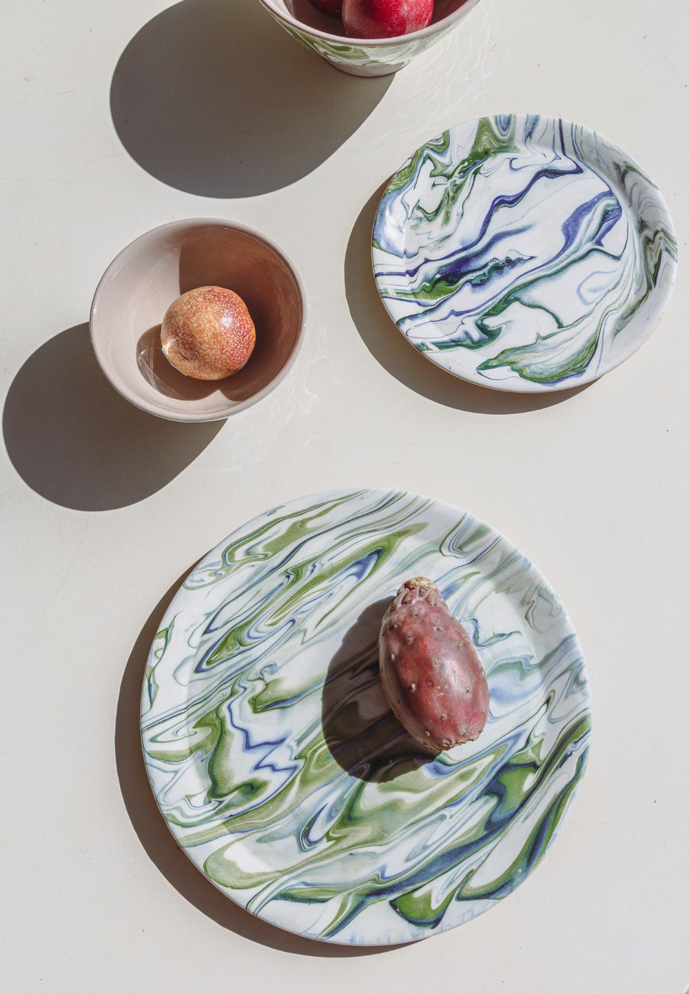 Two marbled ceramic plates with a dessert on a light surface