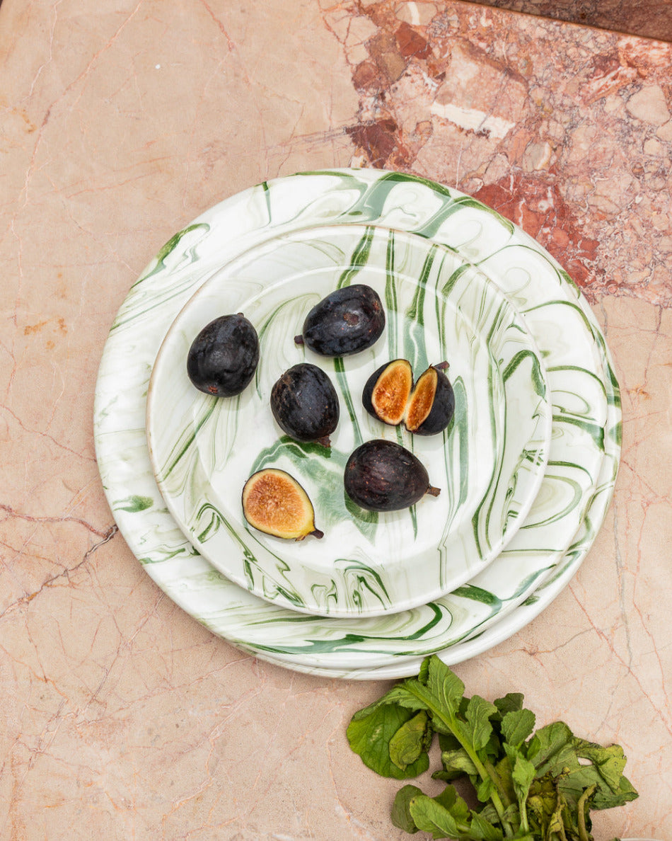 Marbled ceramic plate with figs on a marble surface