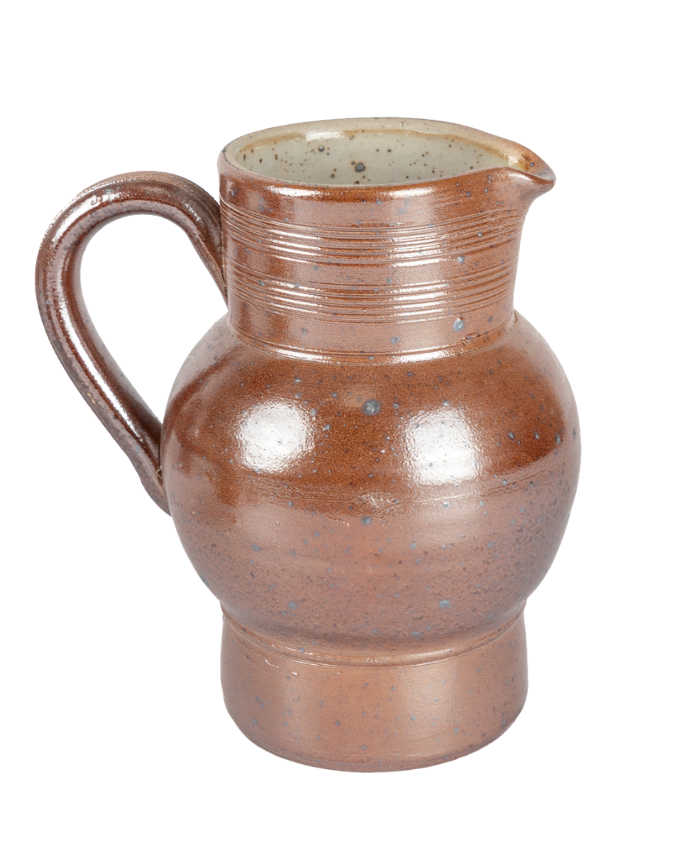 Brown ceramic pitcher on a white background