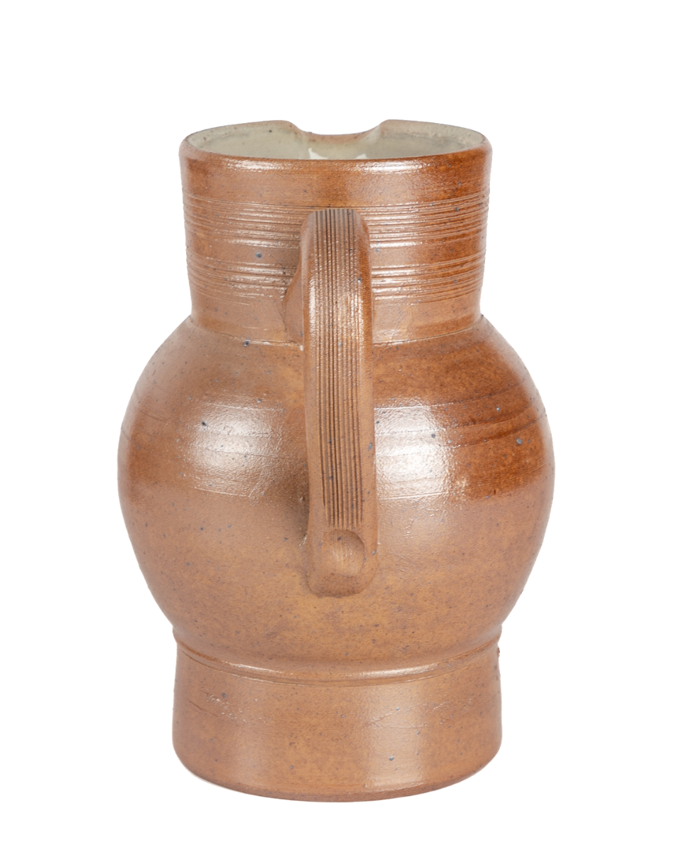 Brown ceramic pitcher on a white background