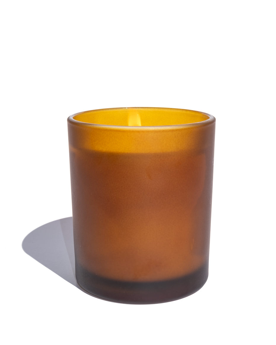 Amber glass candle on a white background