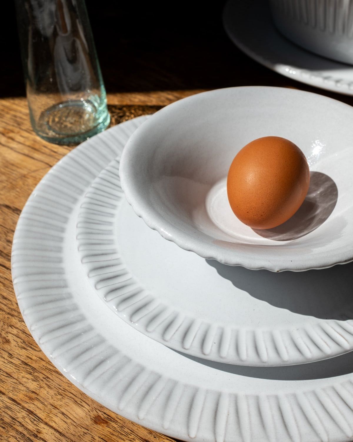 Brown egg on a white ceramic dish with a blurred background