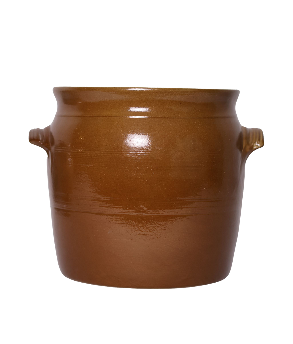 Brown ceramic pot with handles on a white background
