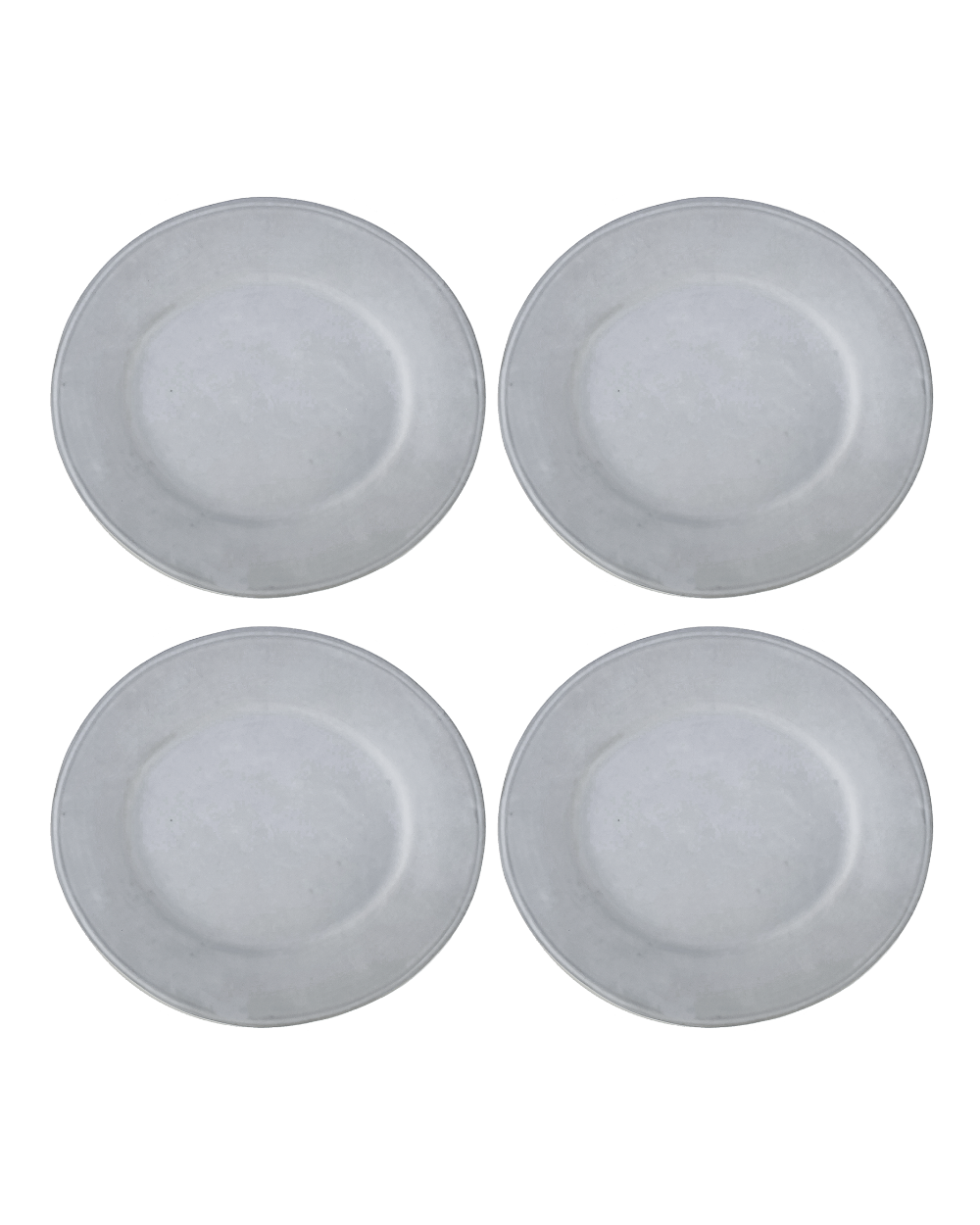 Four white ceramic plates on a white background